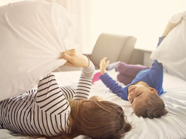 mom and son playing in bed